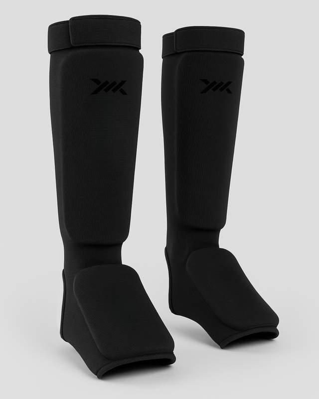 Espinilleras Caged Core – Negro/Negro